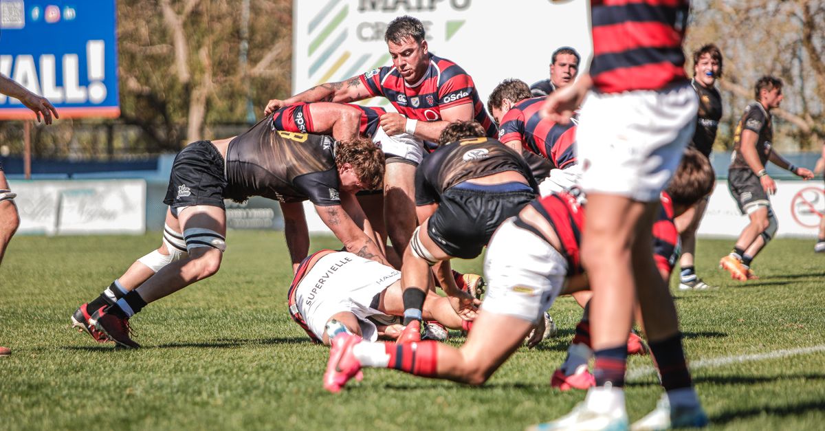 Rugby players competing in a dynamic match outdoors. Fierce action and teamwork on the field.